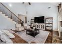 Bright living room featuring hardwood floors, cozy furniture, and a soaring vaulted ceiling at 37 Water Oak Dr, Sharpsburg, GA 30277