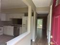 Open layout showcasing kitchen with stainless steel appliances flowing into the living area at 923 Regal Path Ln, Decatur, GA 30030