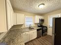 Functional kitchen features granite countertops, stainless steel appliances and white cabinets at 2922 Dale Pl, Decatur, GA 30032