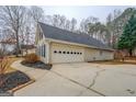 Attached two-car garage with a long driveway and meticulously landscaped flowerbeds at 60 Paden St, Covington, GA 30016