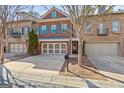 Charming brick townhome with a two-car garage, beautiful shutters and a well-maintained front yard and brick mailbox at 44 Star Spangled Ln, Peachtree City, GA 30269