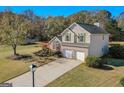 Charming two-story home with brick accents, two-car garage, and well-manicured lawn from an aerial view at 1022 Gloria Grand Blvd, Mcdonough, GA 30252