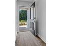 Light, bright entryway with wood look flooring and a dark front door leading to the outdoors at 4856 Station Ln # 21, Union City, GA 30349