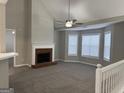 Spacious living room features a fireplace, vaulted ceiling, and large windows at 1913 Boulder Ridge Pkwy, Ellenwood, GA 30294