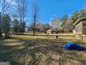 Expansive backyard featuring a shed, blue tarp, and ample space for outdoor activities and relaxation at 8380 Cedar Grove & 8400 Teal Road Rd, Fairburn, GA 30213