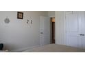 Neutral bedroom featuring light walls, carpet and a doorway with an open door and a closed door at 2297 Knob Creek Dr, Snellville, GA 30078