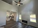 Living room boasting high ceilings, a fireplace, and dark laminate flooring at 140 Tye St, Stockbridge, GA 30281