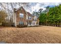 Beautiful two-story home with a stone facade, manicured lawn, and mature trees at 270 Sturgess Run, Sharpsburg, GA 30277