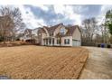 Two-story home boasting a stone facade, attached garage, and spacious front yard at 270 Sturgess Run, Sharpsburg, GA 30277