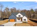 Beautiful home with a modern garage door, appealing brickwork, and a large front yard at 859 N Bay Overlook, Villa Rica, GA 30180