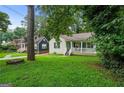 Quaint home with a covered front porch and a beautifully landscaped front yard at 1273 Boulevard Lorraine Sw, Atlanta, GA 30311