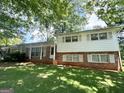 Charming two-story home with a brick and white wood exterior and lush green lawn at 6576 Randall Mark Dr, Morrow, GA 30260