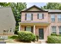 Attractive two-story brick townhome with dark shutters and a manicured front yard at 1406 Bayrose Cir # 6B, East Point, GA 30344
