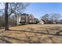 Large brick home with a well-manicured lawn and mature trees at 123 Stratmore Pl, Stockbridge, GA 30281
