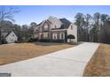 Two-story home with a long driveway and landscaped front yard at 123 Stratmore Pl, Stockbridge, GA 30281