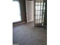 Bedroom featuring neutral carpet, closed french doors, and natural light from the windows at 4111 Pine Heights Ne Dr, Atlanta, GA 30324