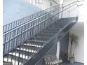 Outdoor staircase with metal railings leading up to the entrance at 4000 Orchard Hill Ter, Stone Mountain, GA 30083