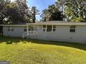 Lovely one-story home with a well-manicured lawn, a welcoming entryway, and plenty of natural light at 47 Elm St, Hampton, GA 30228