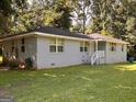 Well-maintained one-story home featuring a classic brick facade and a landscaped yard at 47 Elm St, Hampton, GA 30228