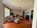 Cozy living room featuring hardwood floors, neutral walls, and comfortable seating arrangements at 47 Elm St, Hampton, GA 30228