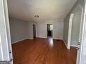 Inviting living room with gleaming hardwood floors, neutral paint, and an open layout at 47 Elm St, Hampton, GA 30228
