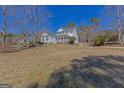 Beautifully maintained two-story home with classic architectural elements and a spacious front lawn at 245 Longshore Way, Fayetteville, GA 30215