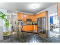 Bright kitchen featuring wooden cabinets, granite countertops, and stainless steel appliances at 176 Fairoaks Cir, Stockbridge, GA 30281