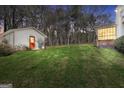 Expansive backyard with lush green lawn, outbuilding, and screened sunroom offers room for outdoor enjoyment at 415 Southmoor Cir, Stockbridge, GA 30281