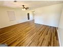 Spacious living room featuring wood-look floors, ceiling fan, and ample natural light at 36 Reese St, Grantville, GA 30220