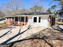View of the exterior elevation displaying a combination of brick and siding, plus an expansive driveway at 1209 Topaz Ln, Villa Rica, GA 30180