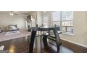 Cozy dining area with sleek dark wood floors and modern table near living space at 536 Caledon Way, Hampton, GA 30228