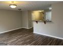 Open-concept living room featuring hardwood floors and neutral paint at 305 Magnolia Gardens Walk, Mcdonough, GA 30253