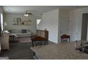 Open-concept living room with hardwood floors, floating shelves and a comfortable couch at 1879 Redfern Rd, Dacula, GA 30019