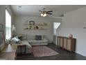 Bright living room with a cozy sectional sofa, decorative shelves, and an accent rug at 1879 Redfern Rd, Dacula, GA 30019