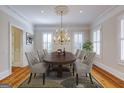 Elegant dining room with a dark wood table, seating for six, and a chandelier overhead at 3786 Turnberry Ct, Duluth, GA 30096