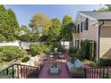 Inviting outdoor patio with comfortable seating, a dining table, and a beautifully landscaped garden area at 3786 Turnberry Ct, Duluth, GA 30096