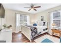 Bright bedroom with wood floors features a ceiling fan and natural light from large windows at 72 Chappell Sw Rd, Atlanta, GA 30314