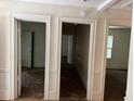 Hallway featuring multiple doorways and worn flooring at 2681 Oldknow Dr, Atlanta, GA 30318