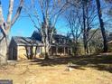 Two-story brick home showcasing a spacious front yard and classic architectural design at 6740 Davidson Ct, Lithonia, GA 30058