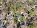 An aerial view showcases this home's location among mature trees and a nearby swimming pool at 4217 Paces Ferry Se Rd, Atlanta, GA 30339