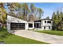 Eye-catching home with modern architecture, a well-manicured lawn, and ample driveway space at 4217 Paces Ferry Se Rd, Atlanta, GA 30339