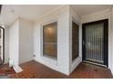 Inviting front porch with white brick and a black framed glass door at 2544 Overlook Dr, East Point, GA 30344