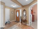 Welcoming foyer with hardwood floors, a decorative mirror, and light-colored walls at 509 Carleton Pl, Locust Grove, GA 30248
