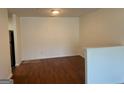 Living room with hardwood floors, white walls, and stainless steel refrigerator in view at 19201 Waldrop Cv, Decatur, GA 30034