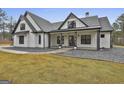 Inviting farmhouse style home with black trimmed windows, gravel landscaping, and covered porch at 285 Hogan Coweta Rd, Hogansville, GA 30230