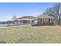 Attractive brick house with large front yard, convenient driveway, and tranquil lake view at 205 Castlewood Rd, Tyrone, GA 30290