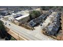Drone shot showcases community's layout with homes, parking, and accessible nearby businesses at 6365 Wellington Walk Way, Lithonia, GA 30058
