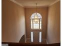 Elegant foyer featuring a grand window, chandelier, and front door, creating a bright and welcoming entrance at 2765 Turning Leaf Dr, Lawrenceville, GA 30044