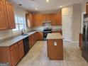 Spacious kitchen equipped with wooden cabinets, an island and modern appliances, perfect for cooking and entertaining at 2765 Turning Leaf Dr, Lawrenceville, GA 30044