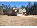Side view of charming home, showing brick accents, side-entry garage and wooded lot at 276 Arborview Dr, Mcdonough, GA 30252